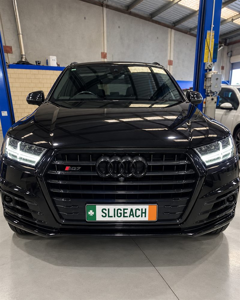 Black Audi SQ7 front view in the workshop