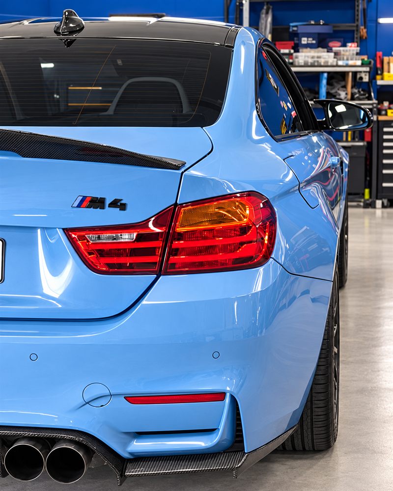 Rear of a blue BMW M4 coupe