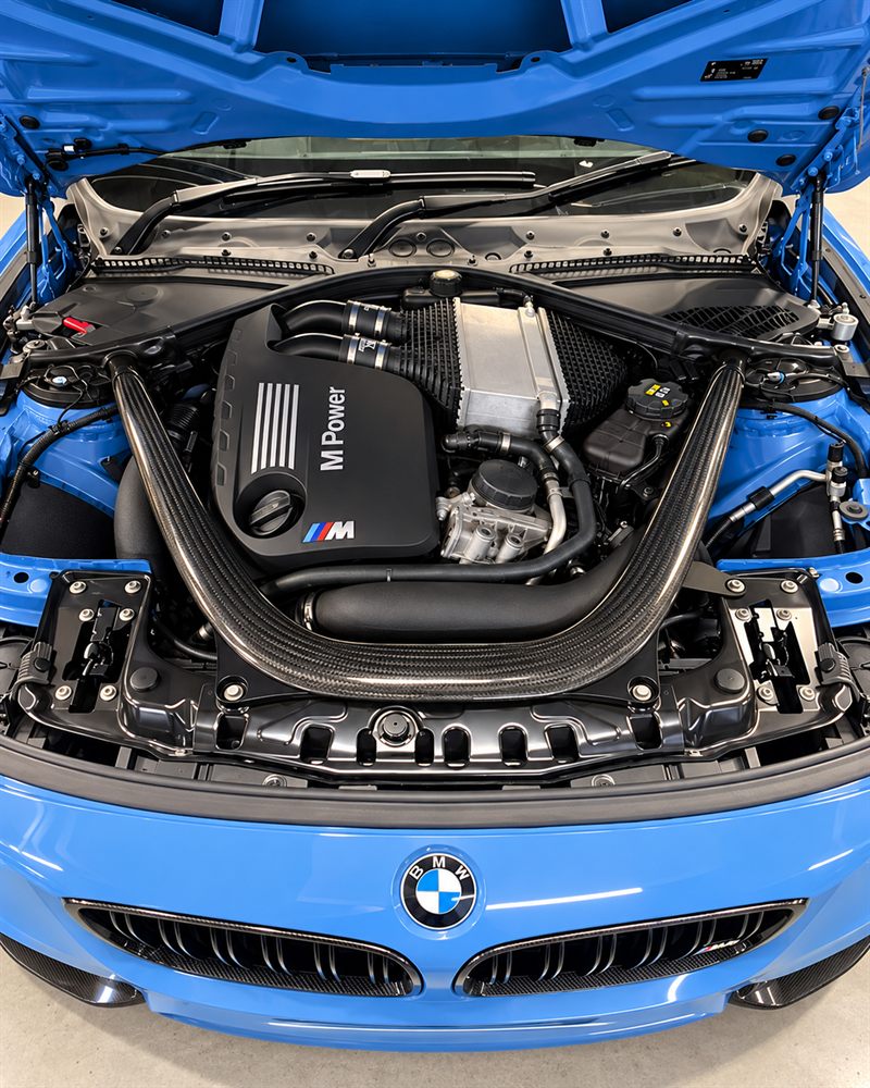 BMW M4 engine bay with M Power cover