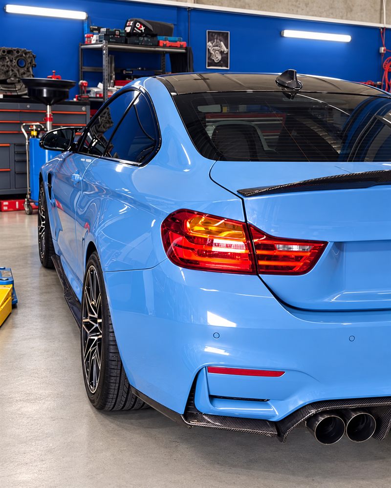 Rear three-quarter view of a blue BMW M4