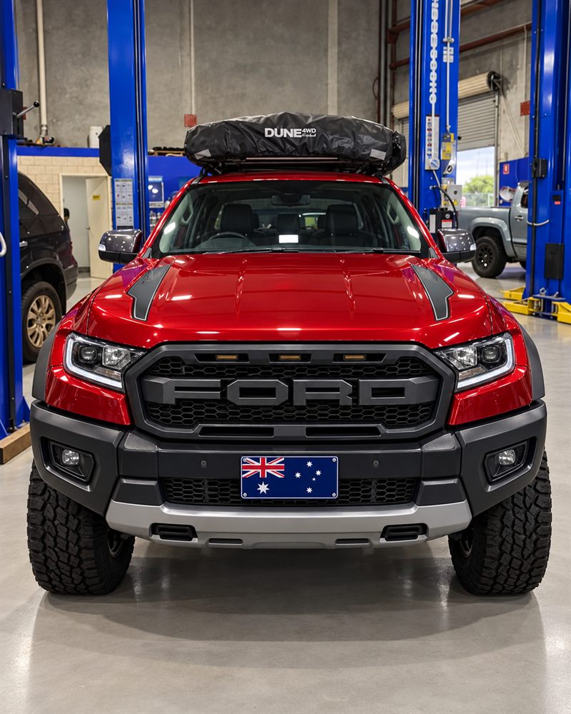 Red Ford Ranger Raptor with a rooftop tent, front view in the workshop