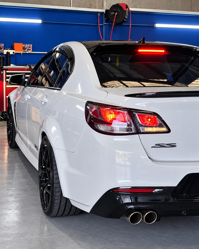Rear three-quarter view of a white Holden VF SS
