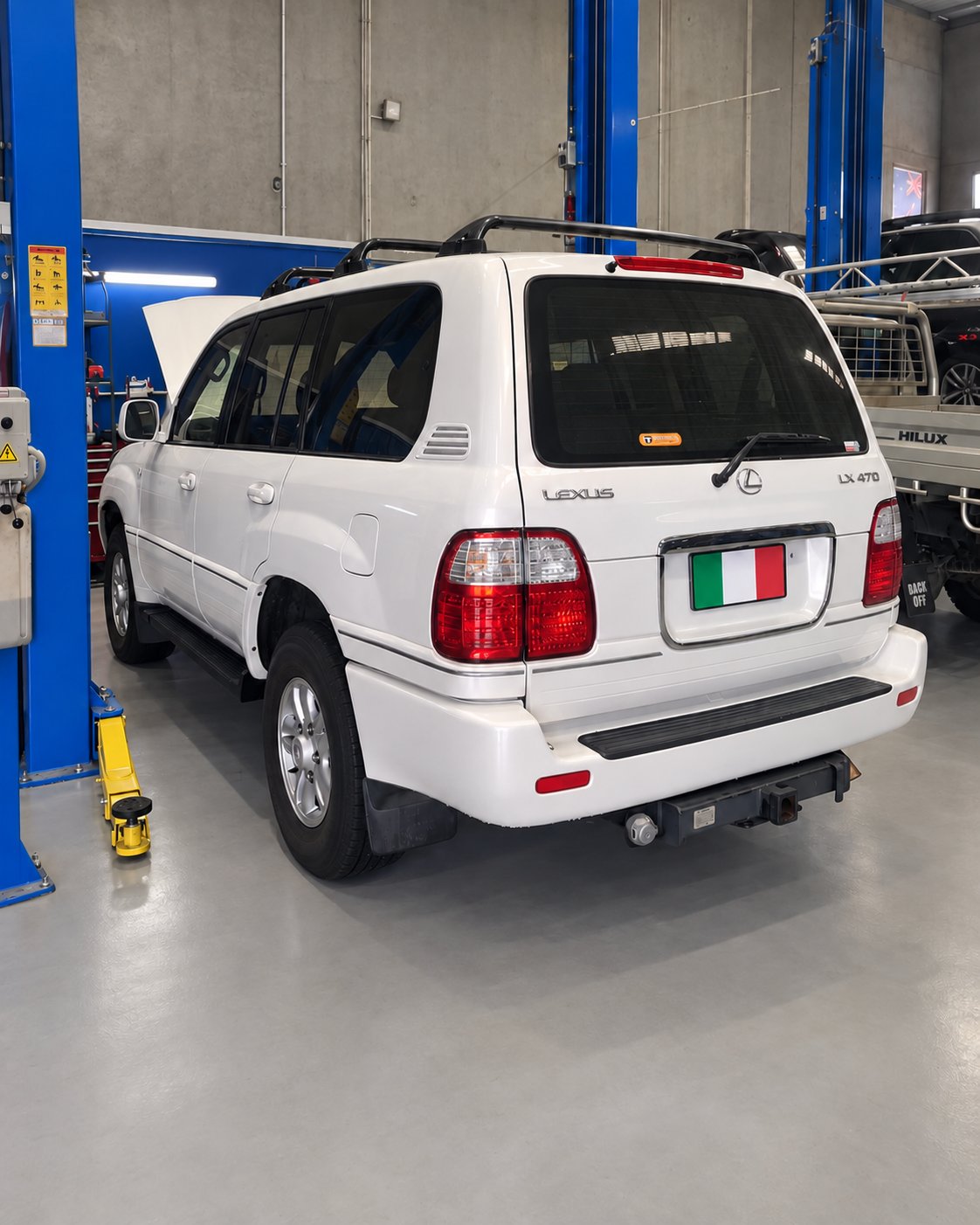 Rear of a white Lexus LX470 in the workshop