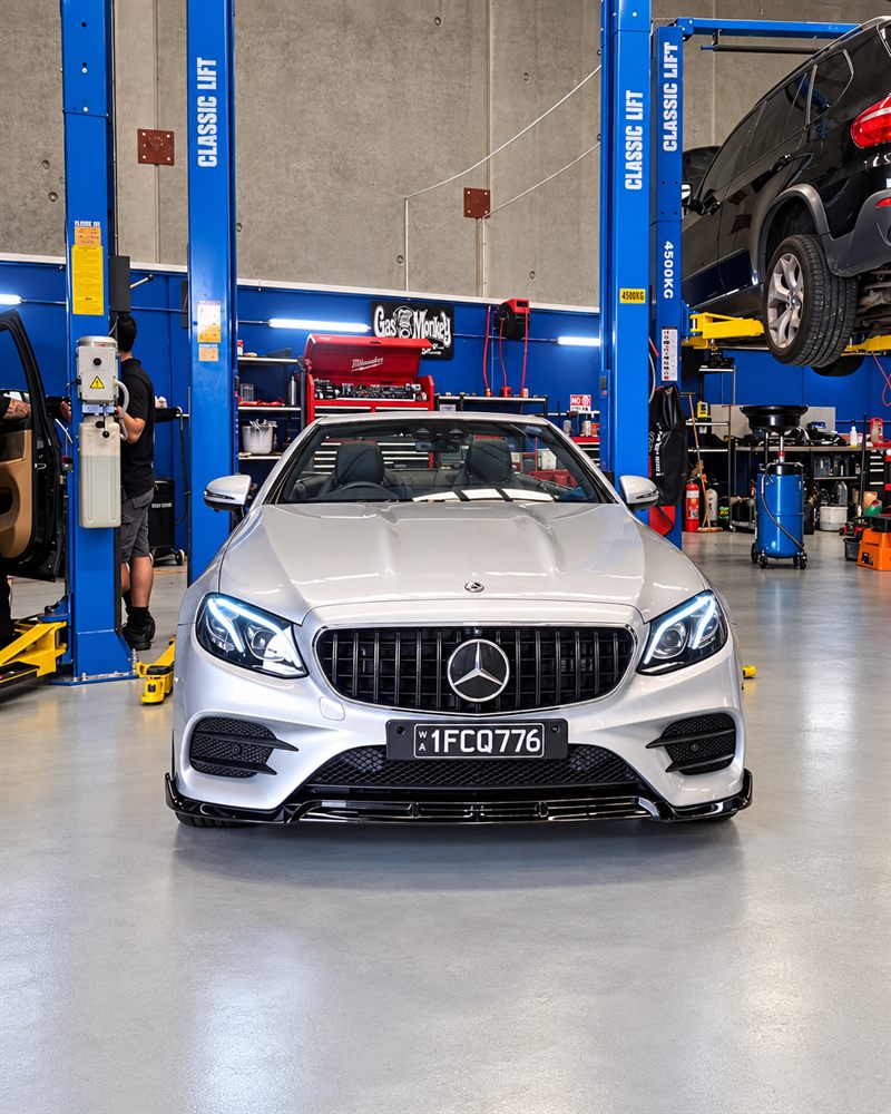 Silver Mercedes-Benz E-Class cabriolet front view in the workshop