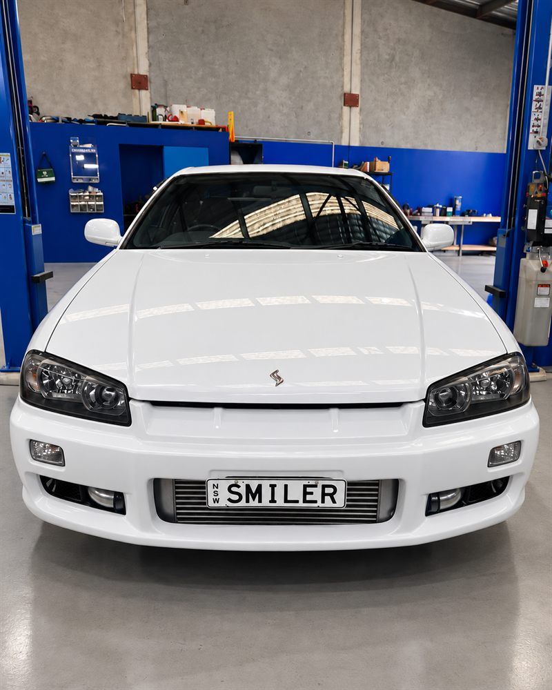 White Nissan Skyline R34 front view in the workshop