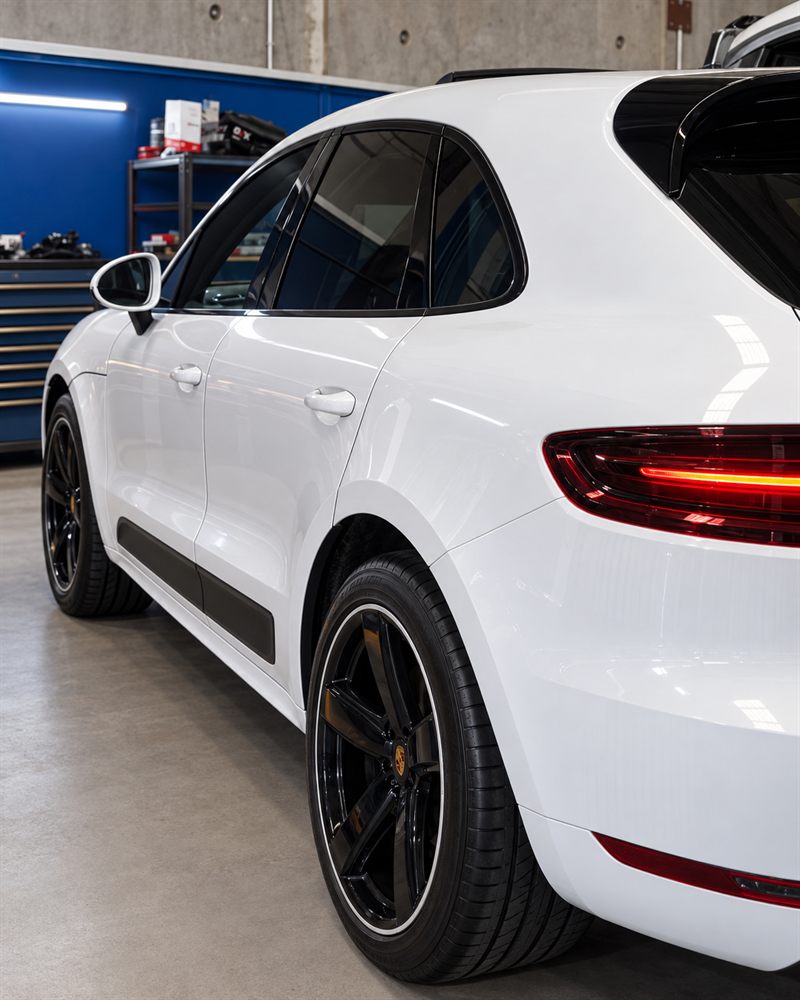 Rear three-quarter view of a white Porsche Macan GTS