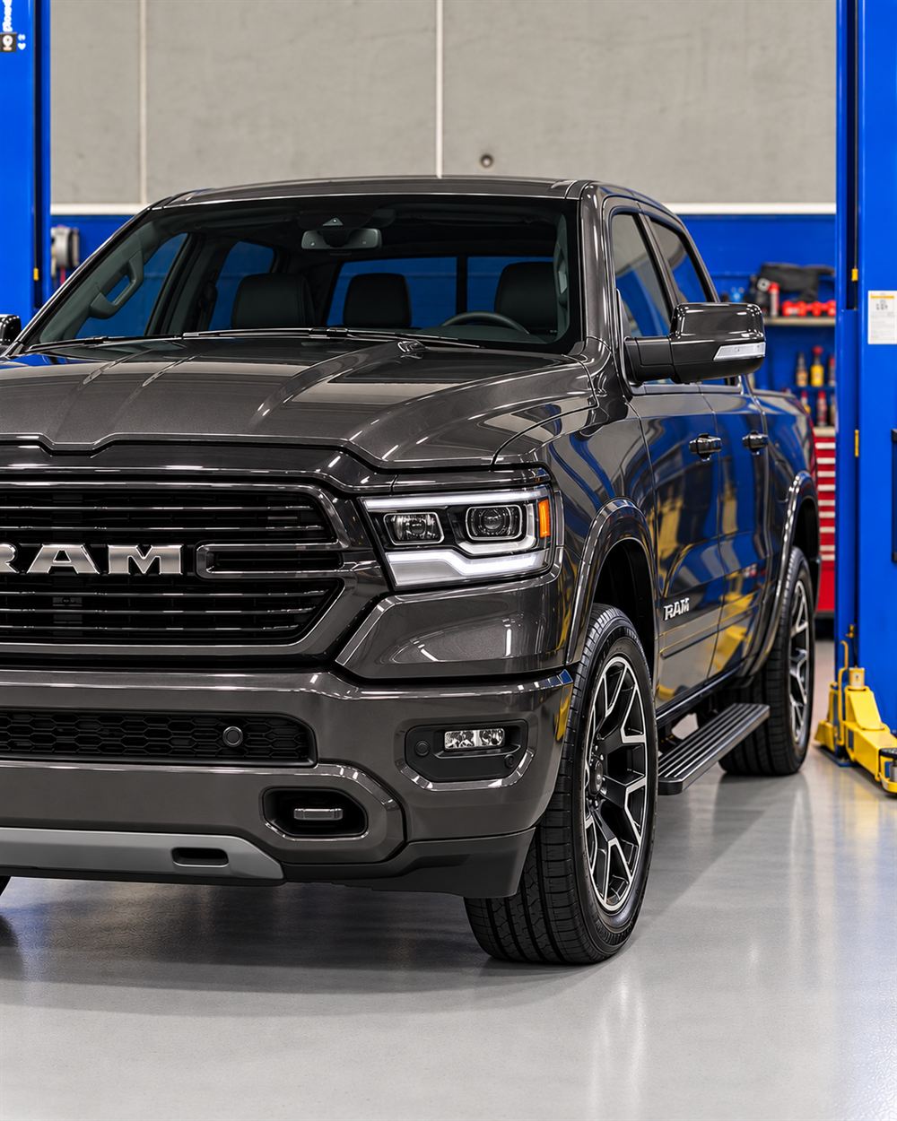 Grey RAM 1500 front view between the hoists