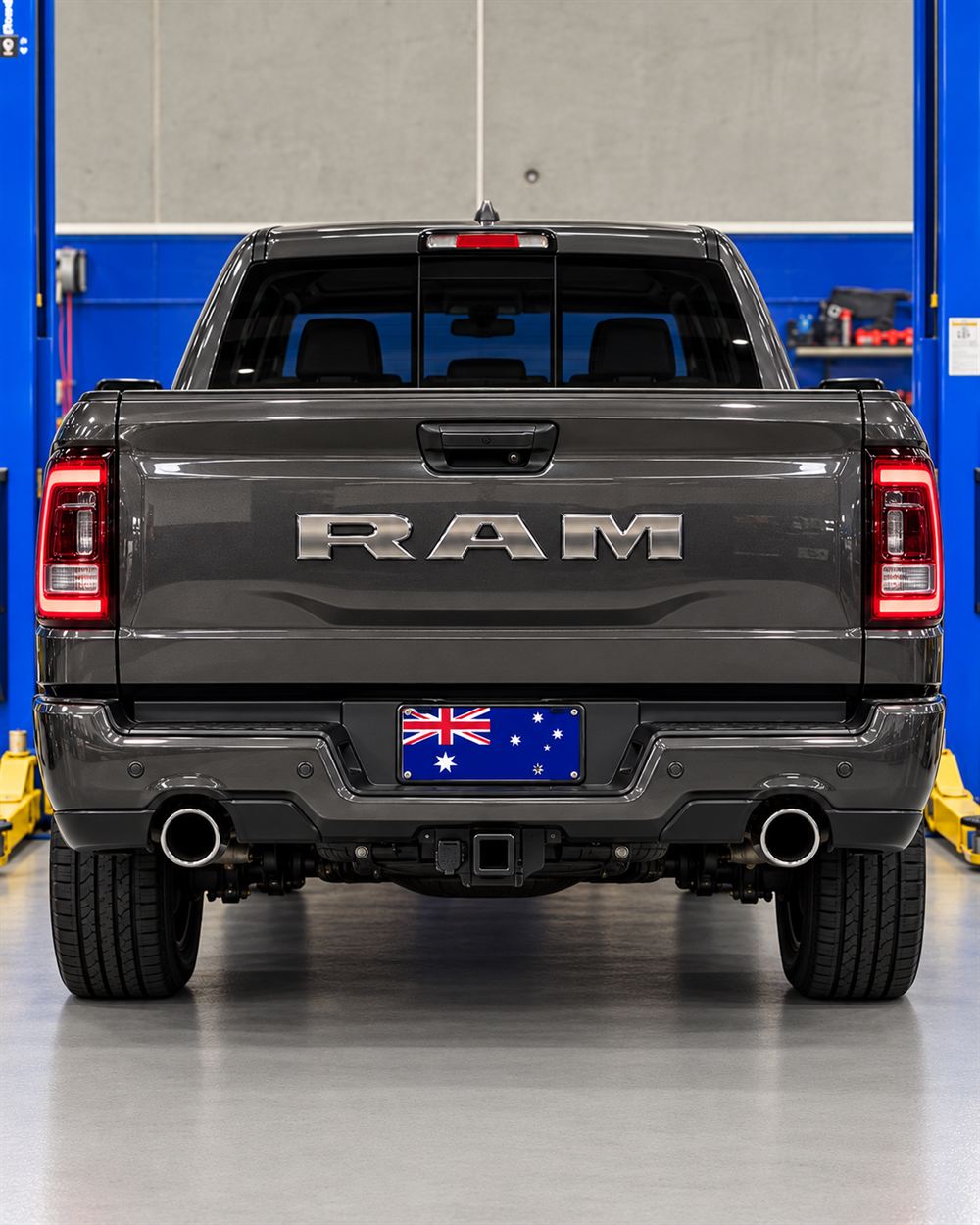 Rear of a grey RAM 1500 with RAM tailgate lettering
