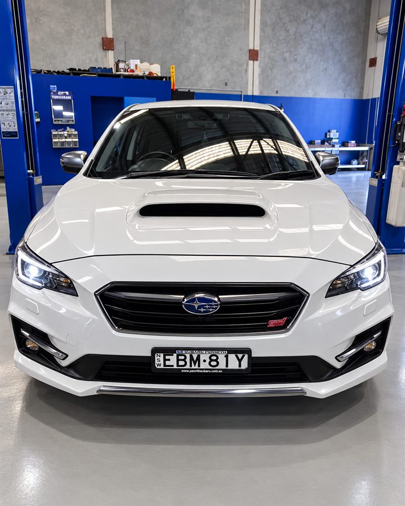 White Subaru WRX STI front view in the workshop