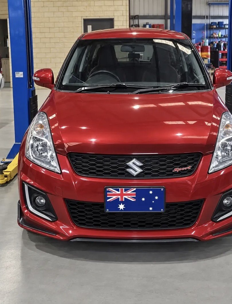 Red Suzuki Swift Sport front view in the workshop