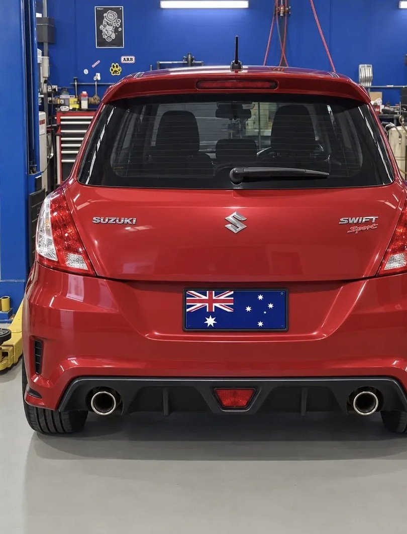 Rear of a red Suzuki Swift Sport with twin exhausts