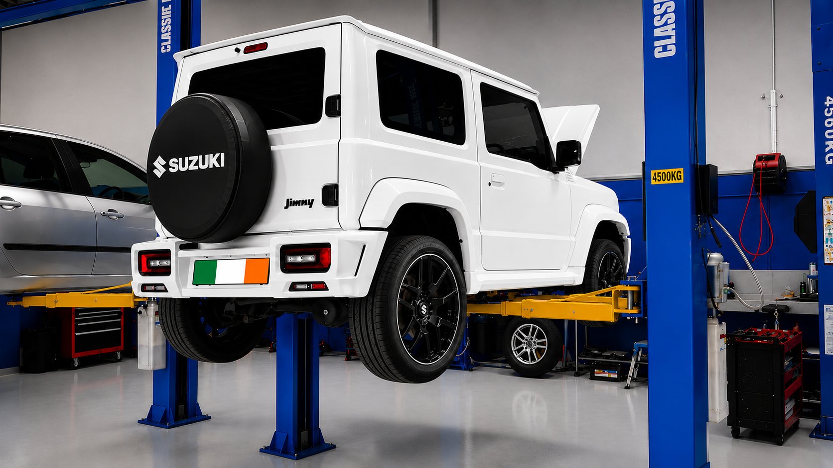 Rear of a white Suzuki Jimny lifted on the hoist
