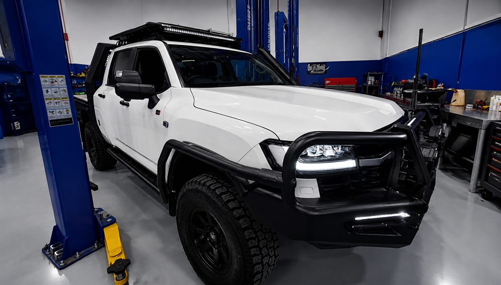 White Toyota 4WD with bull bar and roof rack