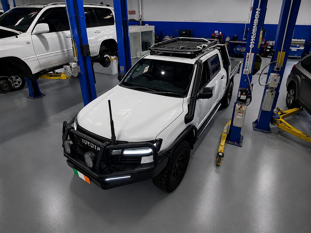 White Toyota LandCruiser with snorkel and roof rack