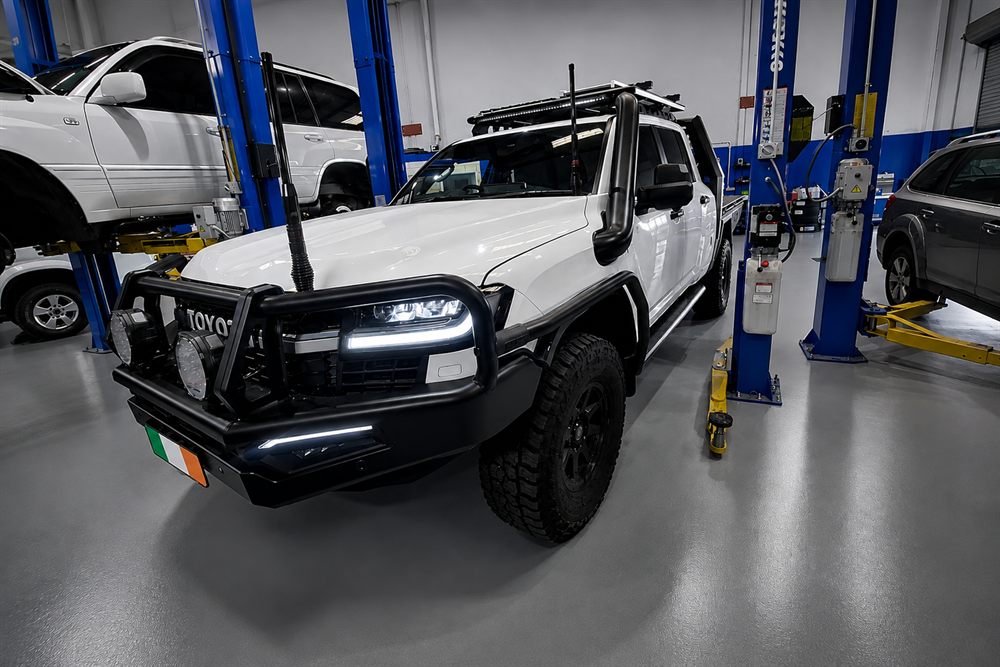 White Toyota LandCruiser with bull bar, snorkel and spotlights