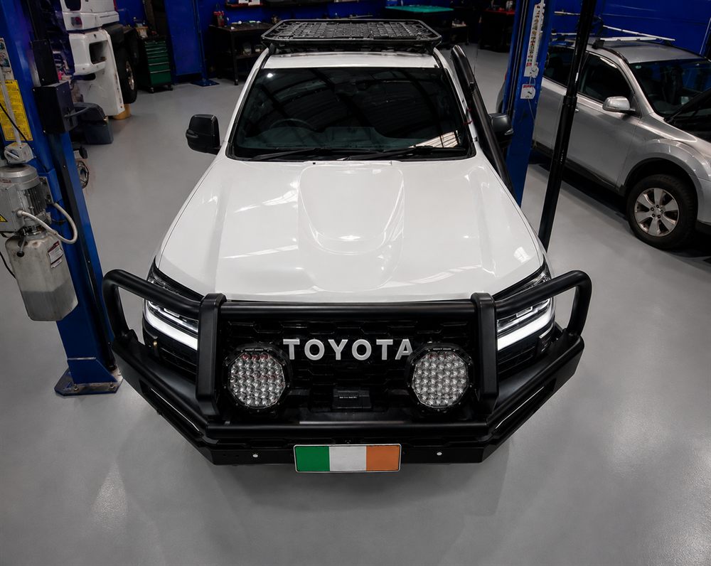 White Toyota with a steel bull bar and spotlights