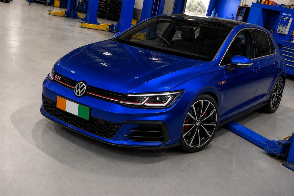 Blue Volkswagen Golf GTI front view between hoists