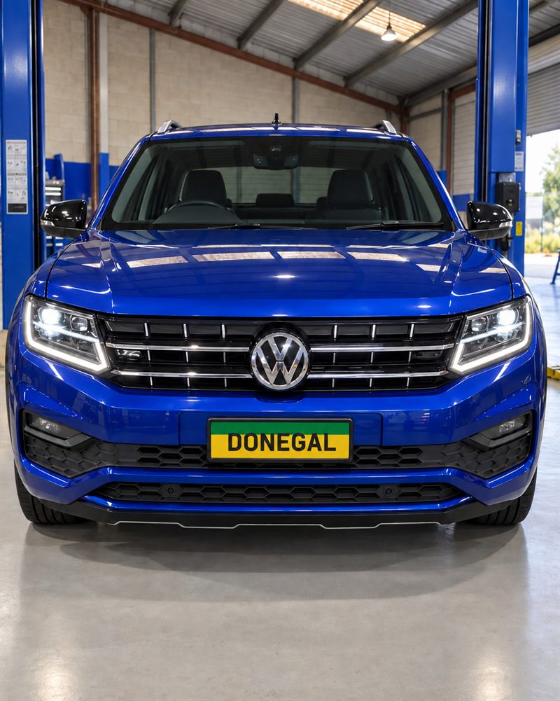 Blue Volkswagen Amarok front view between hoists