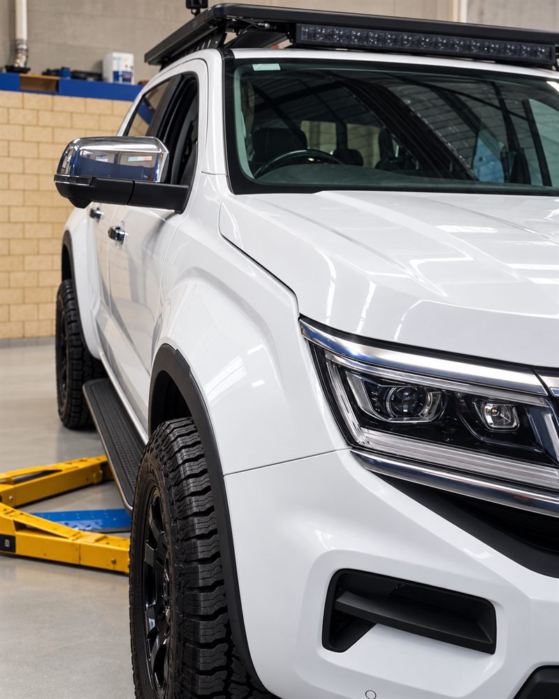 Volkswagen Amarok front three-quarter view on hoist arms