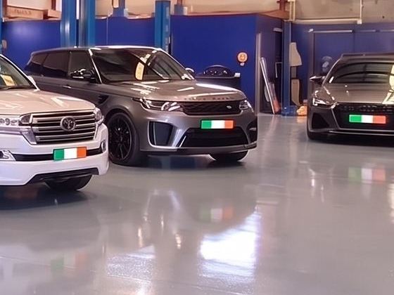 Grey Range Rover Sport parked beside a LandCruiser and Audi