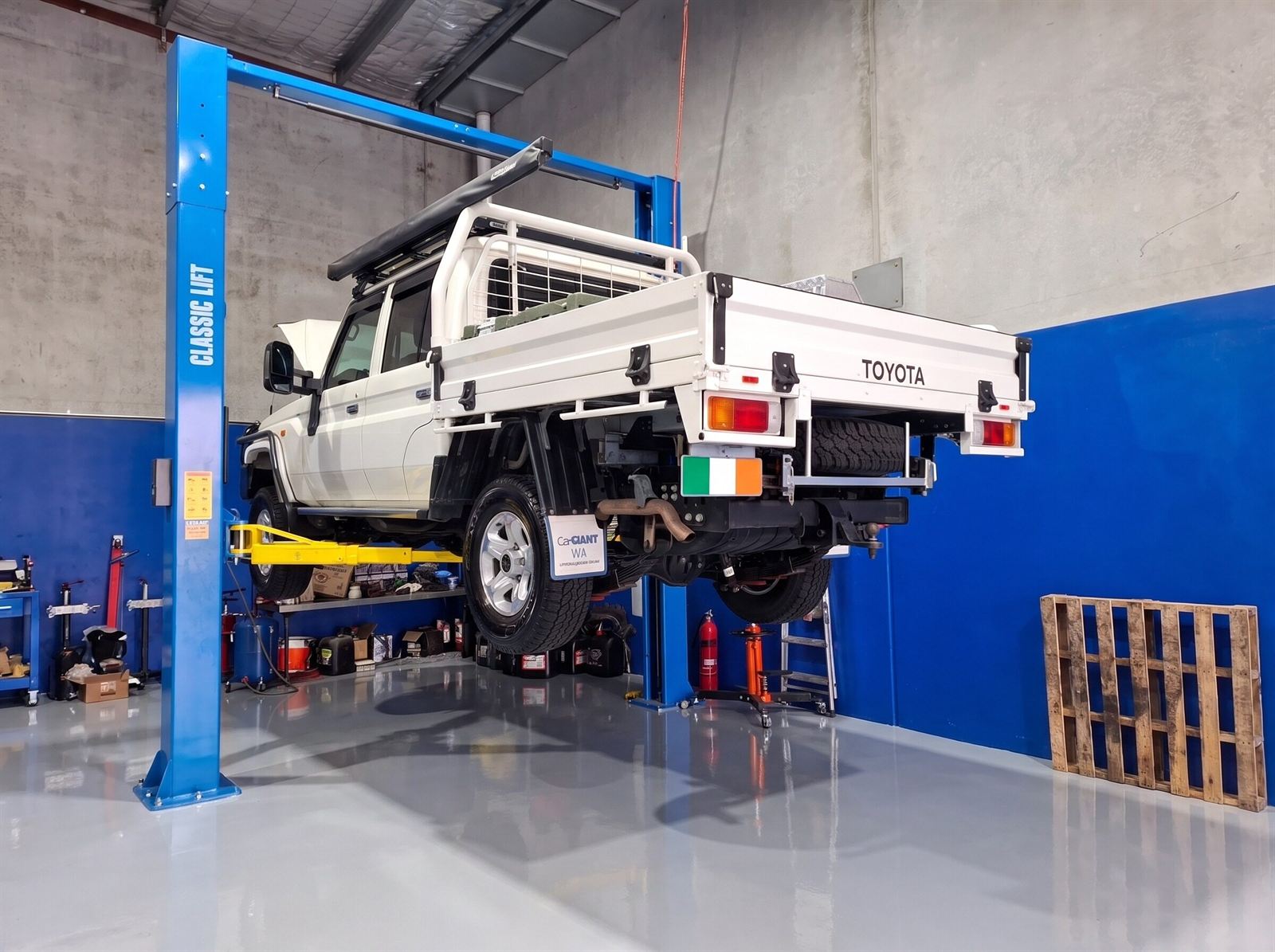 Toyota LandCruiser 70 single-cab tray ute up on a hoist