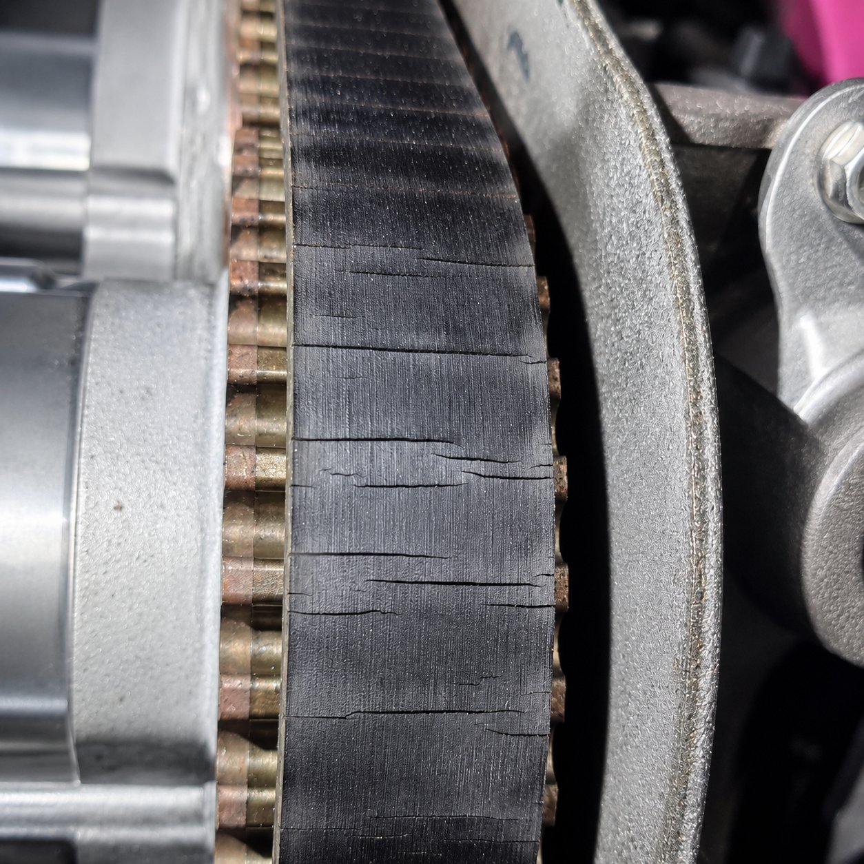 Cracked old timing belt still fitted to the engine
