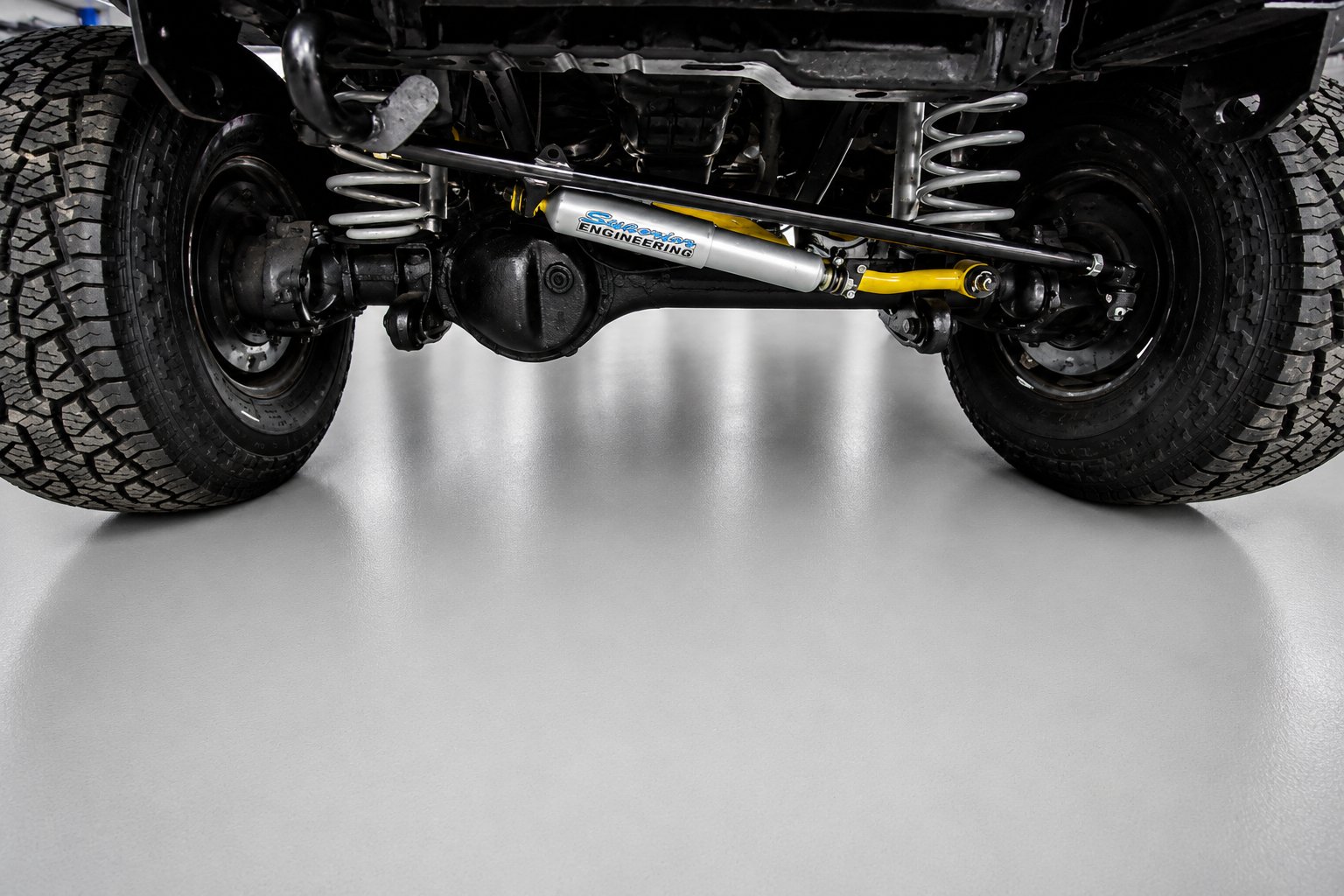 Steering damper and front axle seen from under a Patrol GQ