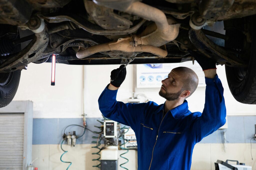 mechanical man seriously working under a car for mechanics malaga